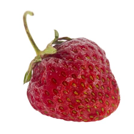 Frozen red strawberries isolated on a white background close-up.の写真素材