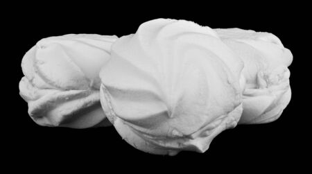 White marshmallows isolated on a black background close-up.の写真素材
