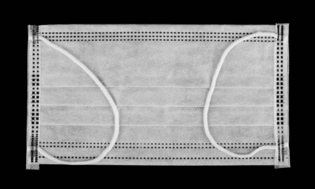 Gauze mask isolated on a black background close-up. View from above.の写真素材