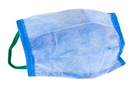 Blue protective mask against corona virus isolated on a white background close-up.の写真素材
