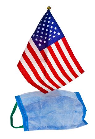 Blue protective mask against the crown virus and the us flag isolated on a white background close-up.の写真素材