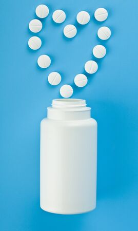 White tablets on a blue background close-up.の写真素材