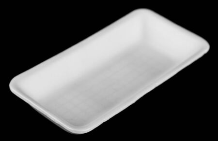 white plate isolated on a black background close-up.の写真素材