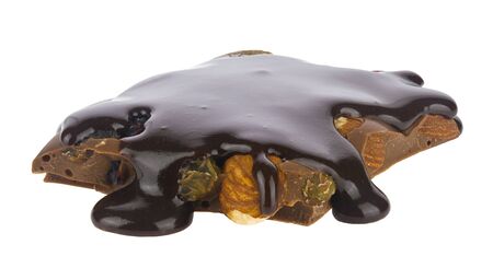 Chocolate with nuts and raisins isolated on a white background close-up.の写真素材