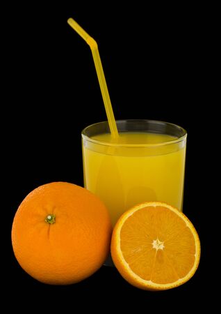 Orange juice and oranges isolated on a black background close-up.の写真素材