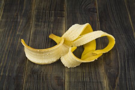 Banana peel on a wooden background.の写真素材