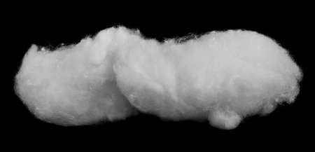 Lump of white fluffy cotton wool isolated on a black background close-up.の写真素材