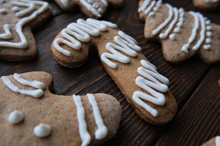 Christmas gingerbread cookies on a brown wooden texture backgroundの写真素材