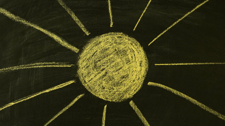 Hand-drawn in chalk yellow sun on the blackboardの写真素材