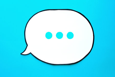 Speech bubble on a blue background. Comic cloud with a three points, process of a typing message