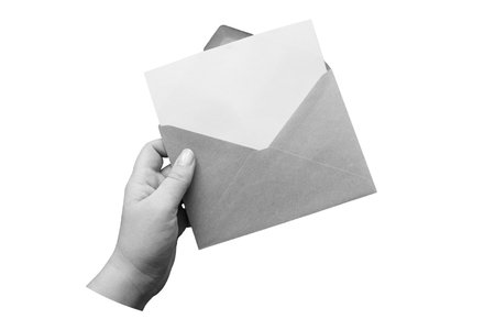 Black and white hand holds a envelope with a blank sheet of paper. Letter template isolated on white...