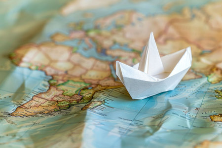 White paper ship on a paper map. Travel. AI generativeの素材