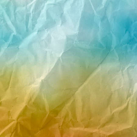 Old crumpled paper in blue and yellow tones for design and space for textの写真素材