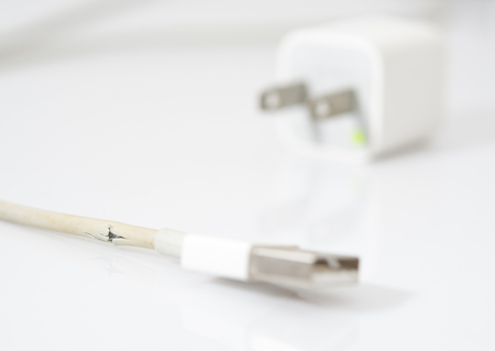 Closeup the Broken Charger Cable on white background