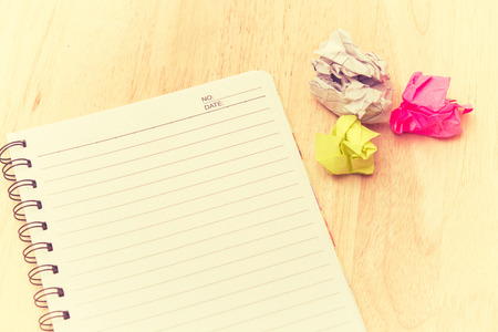 Writers Block. Paper lump. on wooden background.vintage tone.の写真素材