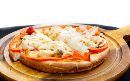 Delicious pizza served on wooden plateの写真素材