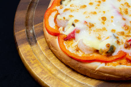 Delicious pizza served on wooden plateの写真素材