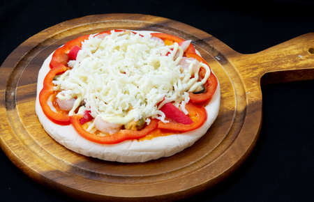 Delicious pizza served on wooden plateの写真素材