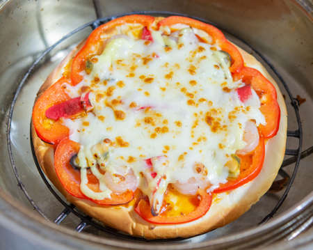 Delicious pizza served on wooden plateの写真素材