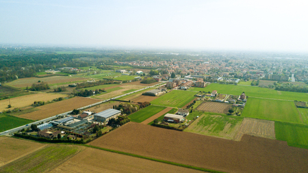 Nature and landscape, municipality of Cesate, Milano: Aerial view of a field, houses and homes, farming, grass green, countryside, farming, trees. italyの写真素材