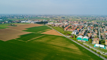 Nature and landscape, municipality of Solaro, Milano: Aerial view of a field, houses and homes, farming, grass green, countryside, farming, trees. italyの写真素材