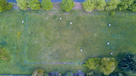 Nature and landscape: Aerial view of a field, plowed field, cultivation, green grass, countryside, farming, haystacks, hay balesの写真素材