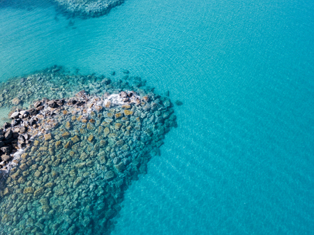 Aerial view of the rocks on the sea. Overview of the seabed seen from above, transparent waterの写真素材