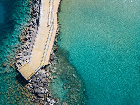 Aerial view of a pier with rocks and rocks on the sea. Pier of Pizzo Calabro, panoramic view from...
