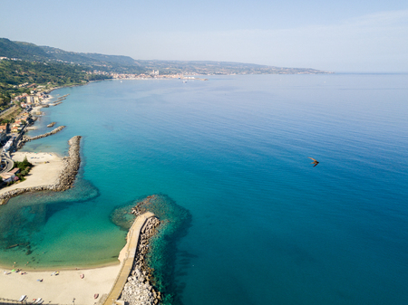 Aerial view of a pier with rocks and rocks on the sea. Pier of Pizzo Calabro, panoramic view from...