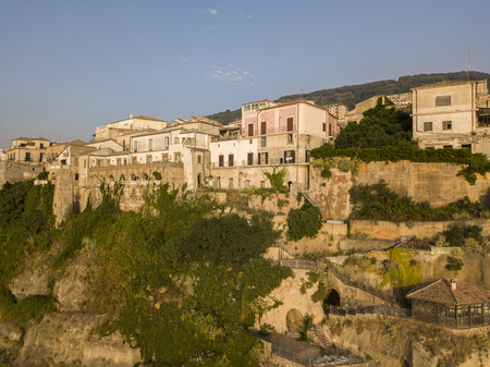 Aerial view of Pizzo Calabro at sunset, Calabria, Italy. Houses on the rock seen from the seaの写真素材