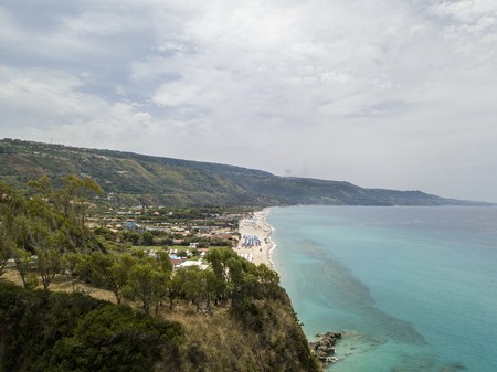 Paradise of the sub, beach with promontory overlooking the sea. Zambrone, Calabria, Italy. Diving relaxation and summer vacations. Italian coasts, beaches and rocks. Aerial viewの写真素材