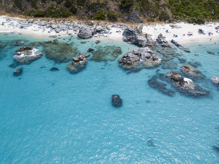 Paradise of the sub, beach with promontory overlooking the sea. Zambrone, Calabria, Italy. Diving relaxation and summer vacations. Italian coasts, beaches and rocks. Aerial viewの写真素材