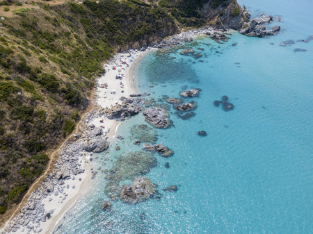Paradise of the sub, beach with promontory overlooking the sea. Zambrone, Calabria, Italy. Diving relaxation and summer vacations. Italian coasts, beaches and rocks. Aerial viewの写真素材