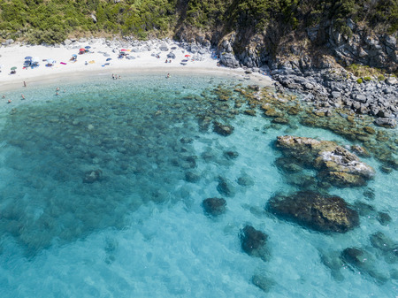 Paradise of the sub, beach with promontory overlooking the sea. Zambrone, Calabria, Italy. Diving relaxation and summer vacations. Aerial viewの写真素材