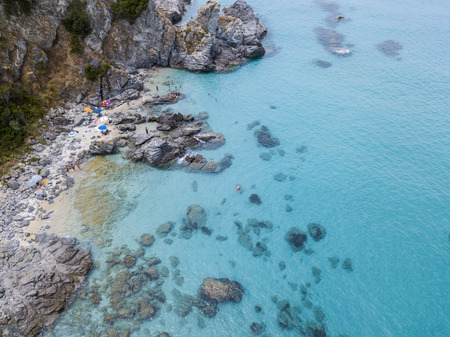 Paradise of the sub, beach with promontory overlooking the sea. Zambrone, Calabria, Italy. Diving relaxation and summer vacations. Italian coasts, beaches and rocks. Aerial viewの写真素材
