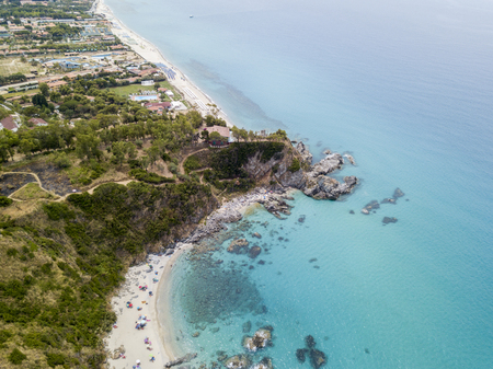 Paradise of the sub, beach with promontory overlooking the sea. Zambrone, Calabria, Italy. Diving relaxation and summer vacations. Italian coasts, beaches and rocks. Aerial viewの写真素材