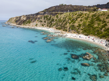 Paradise of the sub, beach with promontory overlooking the sea. Zambrone, Calabria, Italy. Diving relaxation and summer vacations. Aerial viewの写真素材