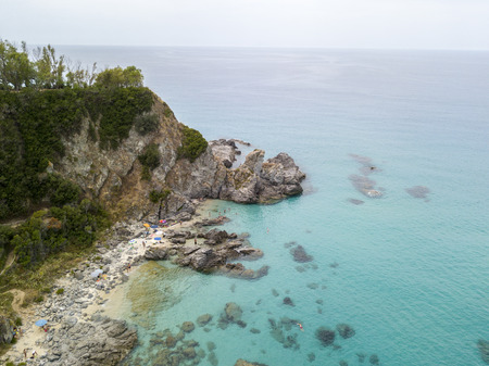Paradise of the sub, beach with promontory overlooking the sea. Zambrone, Calabria, Italy. Diving relaxation and summer vacations. Aerial viewの写真素材