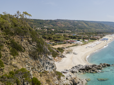 Paradise of the sub, beach with promontory overlooking the sea. Zambrone, Calabria, Italy. Diving relaxation and summer vacations. Aerial viewの写真素材