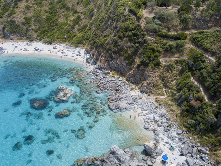 Paradise of the sub, beach with promontory overlooking the sea. Zambrone, Calabria, Italy. Diving relaxation and summer vacations. Aerial viewの写真素材