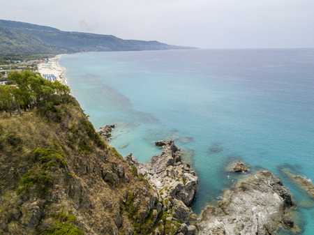 Paradise of the sub, beach with promontory overlooking the sea. Zambrone, Calabria, Italy. Diving relaxation and summer vacations. Aerial viewの写真素材