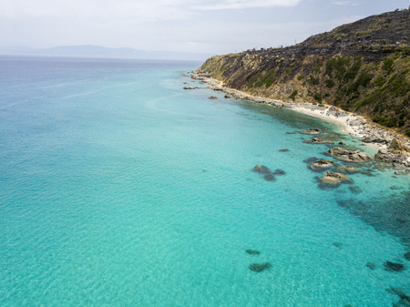 Paradise of the sub, beach with promontory overlooking the sea. Zambrone, Calabria, Italy. Diving relaxation and summer vacations. Aerial viewの写真素材