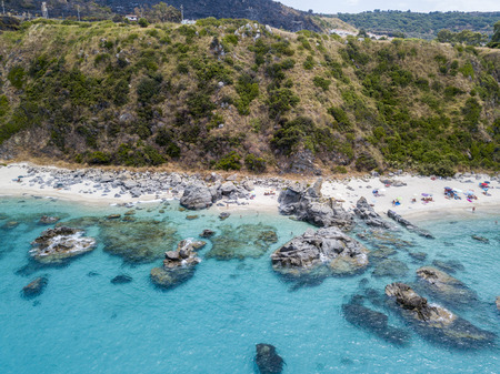 Paradise of the sub, beach with promontory overlooking the sea. Zambrone, Calabria, Italy. Diving relaxation and summer vacations. Aerial viewの写真素材