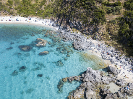Paradise of the sub, beach with promontory overlooking the sea. Zambrone, Calabria, Italy. Diving relaxation and summer vacations. Aerial viewの写真素材