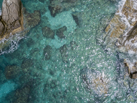 Aerial view of the rocks on the sea. Overview of the seabed seen from above, transparent water