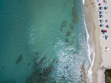 Aerial view of a beach with canoes, boats and umbrellas. Ricadi, Capo Vaticano. Calabria, Italyの写真素材