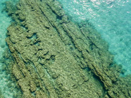 Aerial view of the rocks on the sea. Overview of the seabed seen from above, transparent waterの写真素材