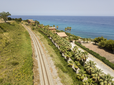 Train tracks crossing the coast with sea views, departing tourist routes. Aerial viewの写真素材