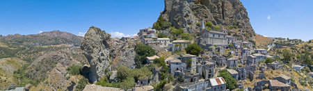 Aerial view of the village of Pentedattilo, church and ruins of the abandoned village, Greek colony on Mount Calvario, whose form recalls the five fingers, the name of the village derives from the Greekの写真素材