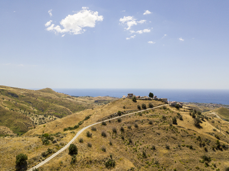 Aerial view of hills and hills in the hinterland of Calabria, overlooking the Ionian Sea. Volcano Etna and Sicily in the backgroundの写真素材